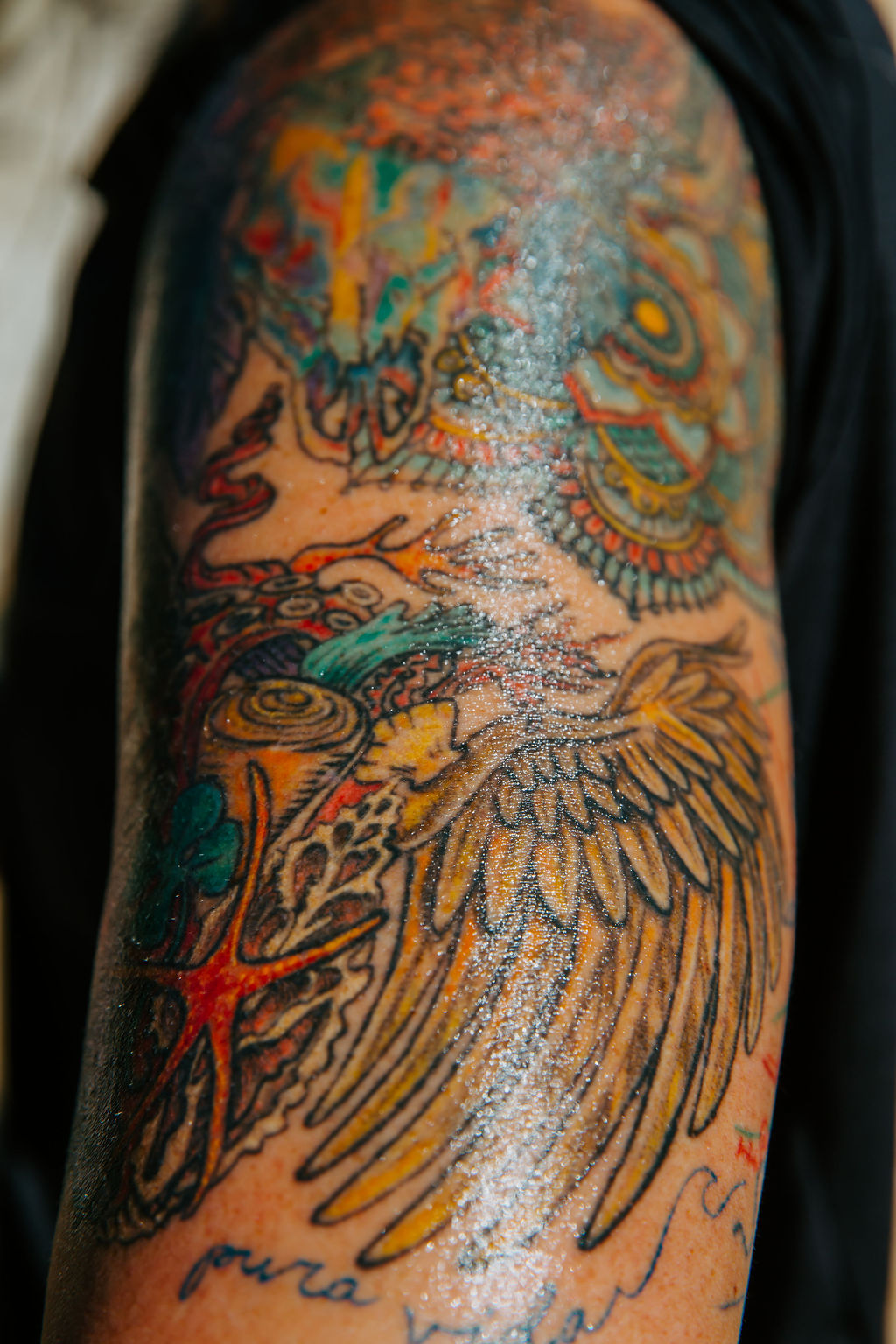 Detailed colorful tattoo on an upper arm
